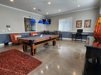 an entertainment center with a pool table and a bar